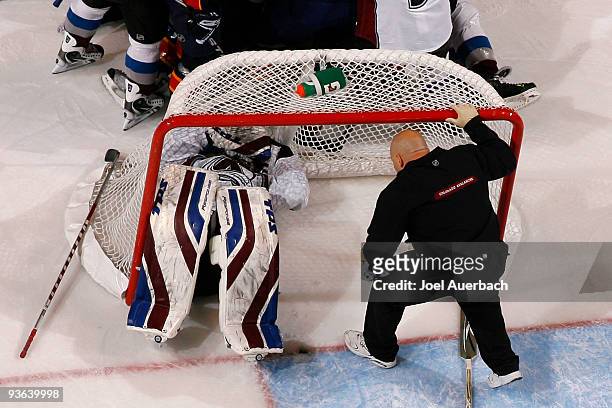 Goaltender Craig Anderson of the Colorado Avalanche lays on the ice after being injured in an collision with Keith Ballard of the Florida Panthers on...