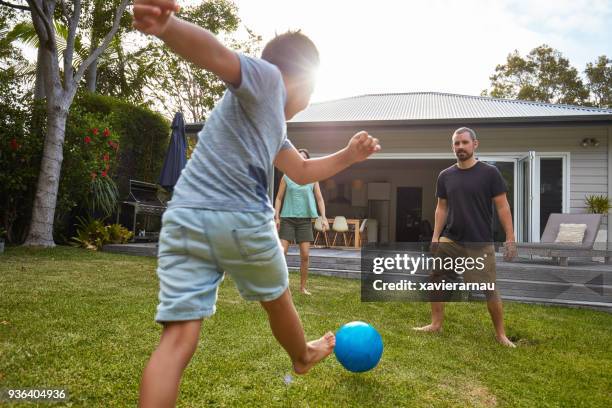 australische jongen spelen met ouders in de achtertuin-tuin - family back yard stockfoto's en -beelden