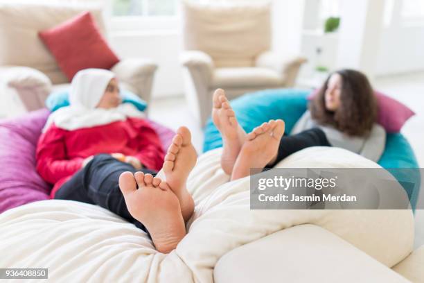 friends relaxed at home - hijab feet stock pictures, royalty-free photos & images