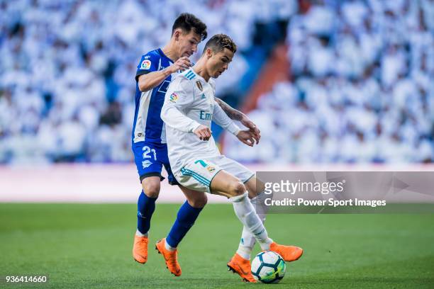Cristiano Ronaldo of Real Madrid fights for the ball with Hernan Arsenio Perez of Deportivo Alaves during the La Liga 2017-18 match between Real...