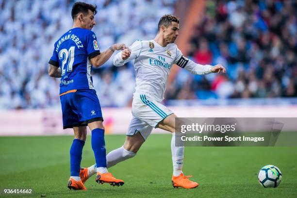 Cristiano Ronaldo of Real Madrid fights for the ball with Hernan Arsenio Perez of Deportivo Alaves during the La Liga 2017-18 match between Real...