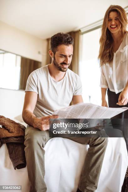 couple reading the newspaper on the hotel - read and newspaper and bed stock pictures, royalty-free photos & images