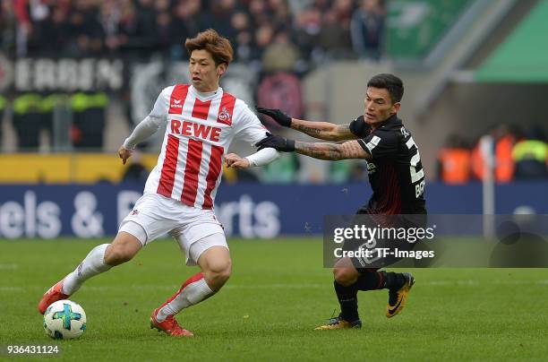 Yuya Osako of Koeln and Charles Aranguiz of Leverkusen battle for the ball during the Bundesliga match between 1. FC Koeln and Bayer 04 Leverkusen at...