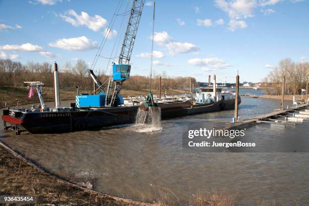 dredger cleans the harbor basin - dredger stock pictures, royalty-free photos & images