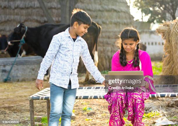 brother and sister using laptop - 13 years old girl in jeans stock pictures, royalty-free photos & images