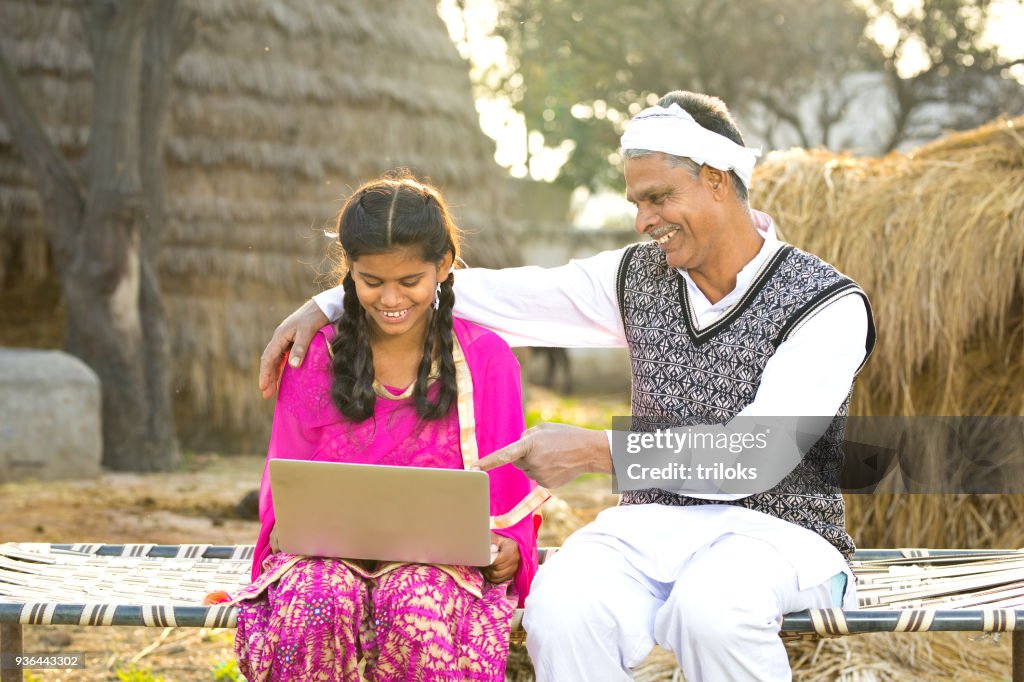Father with daughter using laptop