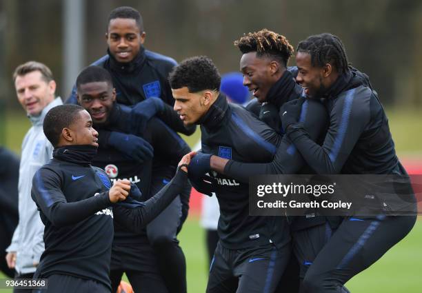 Josh Onomah, Tammy Abraham, Dominic Solanke and Ademola Lookman perform a drill during an England U21 training session at St Georges Park on March...