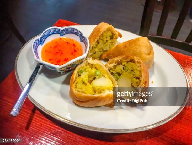 indian food samosas halved served in plate on table with dipping sauce - samosa stock pictures, royalty-free photos & images