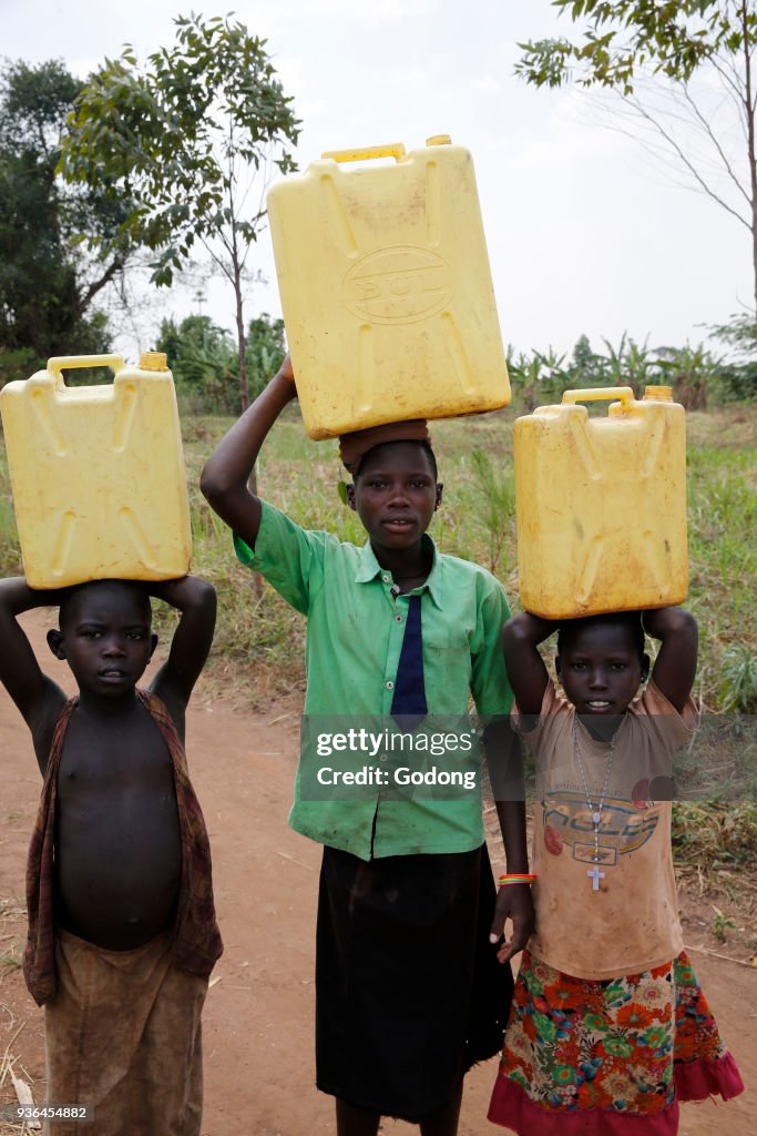 Ugandan children fetching water