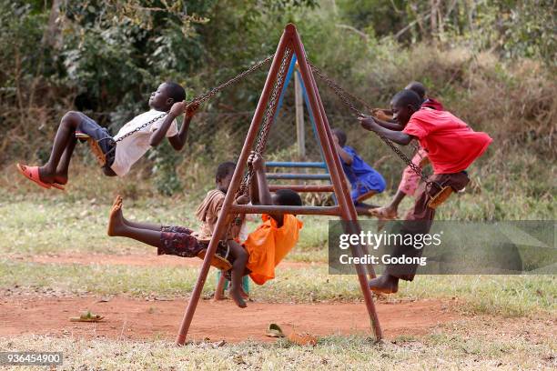 Ugandan children on swings. Uganda.
