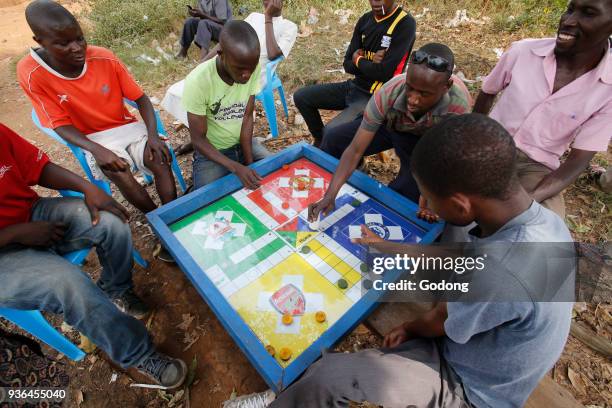 Men playing a game in Mulago. Uganda.