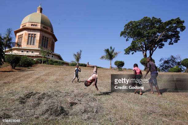 Kampala boys making somersaults in the Baha'i gardens. Uganda.