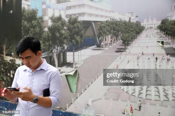 Man using a smartphone. Ho Chi Minh City. Vietnam.