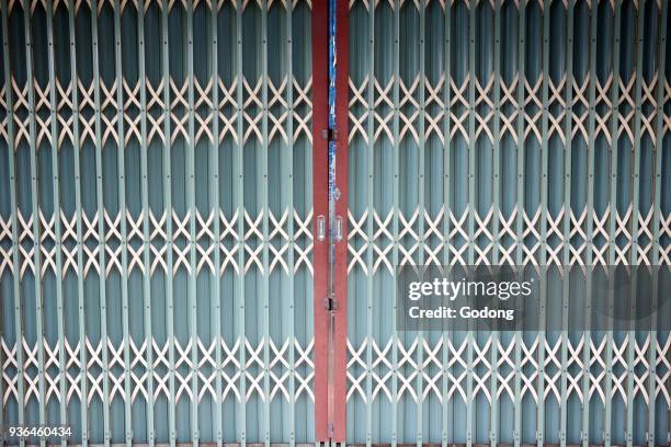 Exterior Of Closed Store. Metal gate. Ho Chi Minh City. Vietnam.