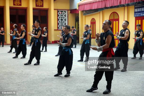 Men practicing martial arts in a buddhist temple. Ho chi Minh City. Vietnam.