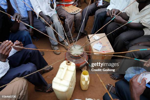 Ugandan villagers drinking home-brewed beer. Uganda.