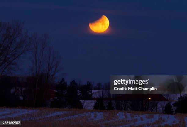 partial lunar eclipse in winter - phase image stock pictures, royalty-free photos & images