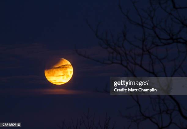 partial lunar eclipse in winter - phase image stock pictures, royalty-free photos & images