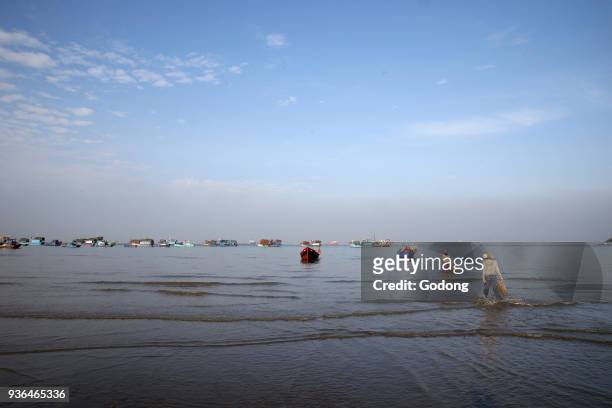 Vung Tau beach. Fishing boats. Women sorting fishing catch. Vietnam. Vietnam.