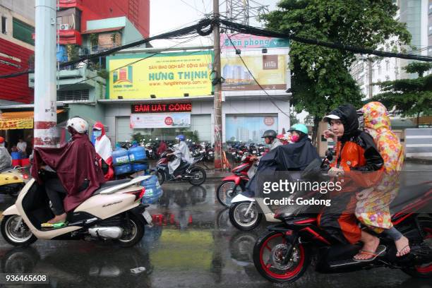 Vietnam, Ho Chi Minh City. Heavy monsoon rain. Motor Scooters on Saigon Street. Ho Chi Minh City. Vietnam.