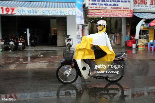 Vietnam, Ho Chi Minh City. Heavy monsoon rain. Motor Scooters on Saigon Street. Ho Chi Minh City. Vietnam.