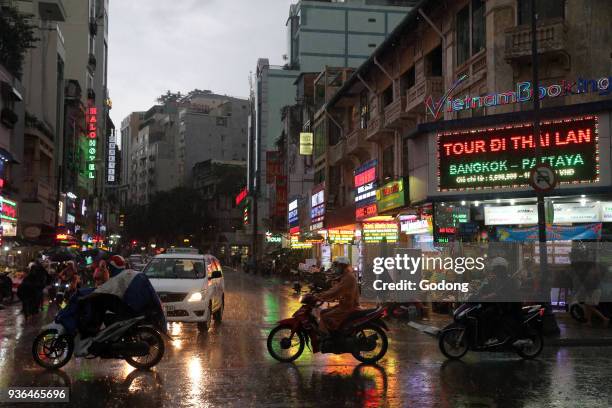 Heavy monsoon rain. Motor Scooters on Saigon Street. Vietnam.