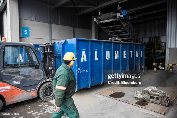 Scrap metal is loaded into a container by conveyor belt by the storage warehouse at the Alumetal Group Hungary Kft. Aluminium processing plant in...