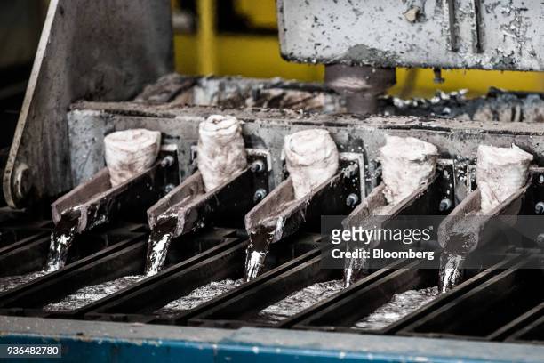Molten aluminum pours from a molding machine at the Alumetal Group Hungary Kft. Aluminium processing plant in Komarom, Hungary on Monday, March 19,...