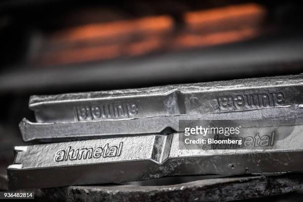 An Alumetal logo sits on aluminum ingots in a warehouse ahead of shipping at the Alumetal Group Hungary Kft. Aluminium processing plant in Komarom,...