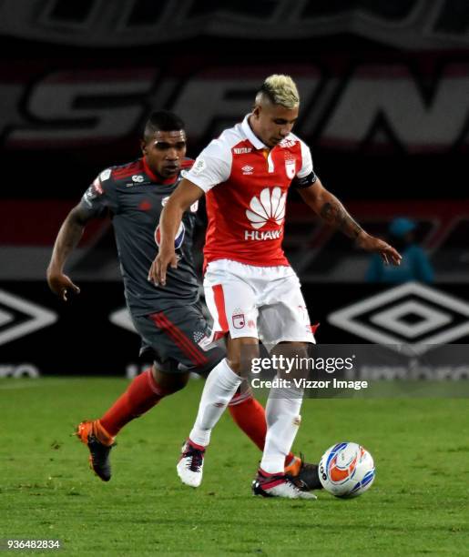 Juan Daniel Roa of Independiente Santa Fe struggles for the ball with Elkin Blanco of America de Cali during a match between Independiente Santa Fe...