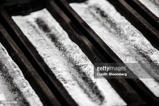 Molten aluminum sits inside ingot moulds at the Alumetal Group Hungary Kft. Aluminium processing plant in Komarom, Hungary on Monday, March 19, 2018....