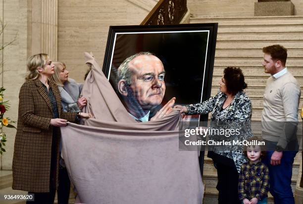 Bernie McGuinness alongside family members unveils the official Assembly portrait of her late husband and the former Deputy First Minister Martin...