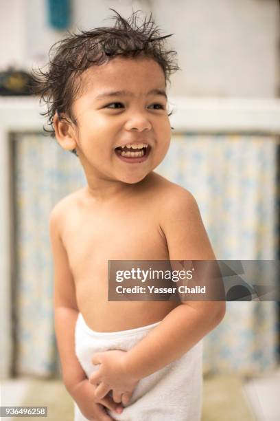 boy wrapped in towel - boy taking a shower stock-fotos und bilder