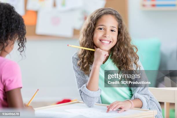 schoolgirl working on math worksheet - back to school party stock pictures, royalty-free photos & images