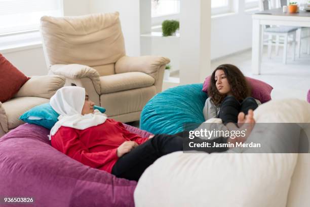 girls having relaxed time on big pillows - arab family in hotel stock-fotos und bilder