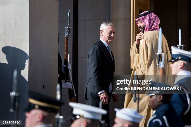 Secretary of Defense James Mattis and Saudi Arabia's Crown Prince Mohammad Bin Salman walk towards the Pentagon during an honor cordon March 22, 2018...