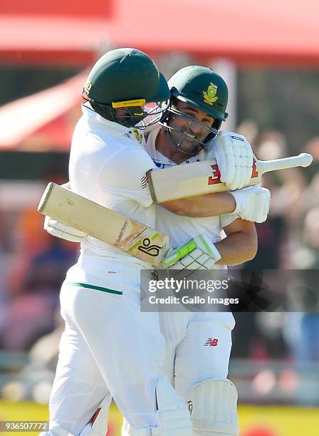 De Villiers of South Africa celebrates with Dean Elgar of South Africa after scoring 100 runs during day 1 of the 3rd Sunfoil Test match between...