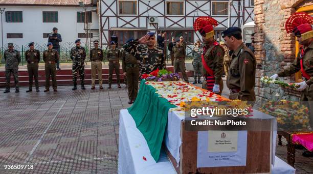 Honor guards of Indian policemen honor their comrade, Deepak Thusoo, killed in a gun battle with suspected rebels, during his wreath laying ceremony...