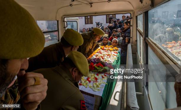 Indian police officers carry the coffin containing the body of their comrade, Deepak Thusoo, killed in a gun battle with suspected rebels, during his...