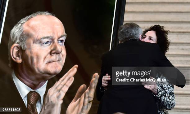 Bernie McGuinness, wife of the late Martin McGuinness is embraced by former Sinn Fein president Gerry Adams as the unveiling of the official Assembly...