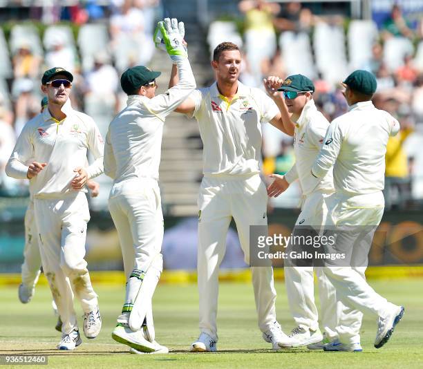 Josh Hazlewood of Australia celebrates the wicket of Hashim Amla of South Africa during day 1 of the 3rd Sunfoil Test match between South Africa and...