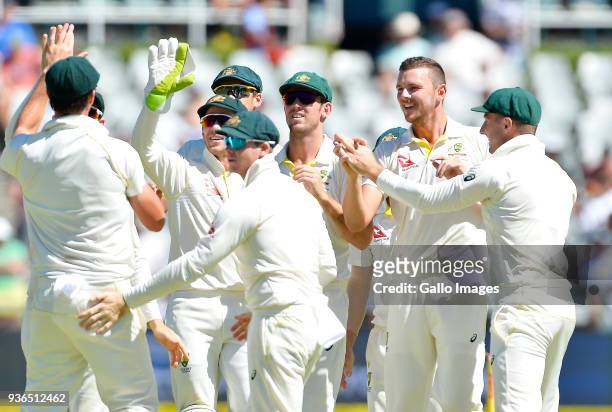 Josh Hazlewood of Australia celebrates the wicket of Hashim Amla of South Africa during day 1 of the 3rd Sunfoil Test match between South Africa and...