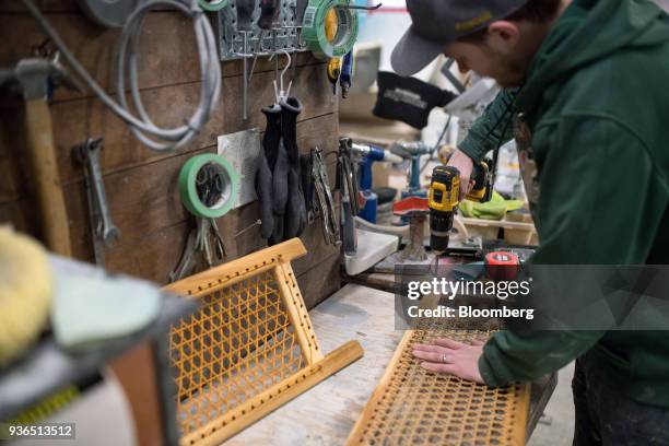 Worker uses a drill while making a seat for a canoe at the Holy Cow Canoe Co. Production facility in Guelph, Ontario, Canada, on Thursday, March 1,...