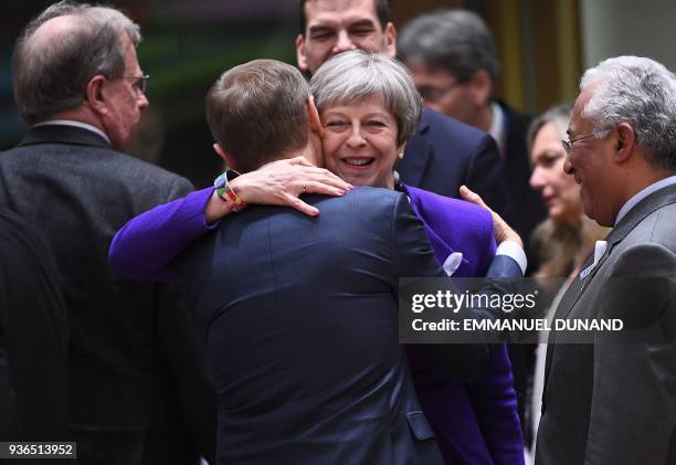 Britain's Prime minister Theresa May greets European Council President Donald Tusk as they attend a European leaders summit at the European Council...