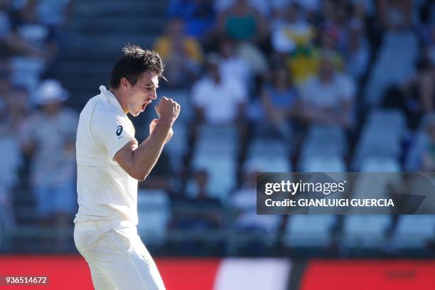 Australian bowler Pat Cummins celebrates the dismissal of South African batsman Temba Bavuma during the first day of the third Test cricket match...