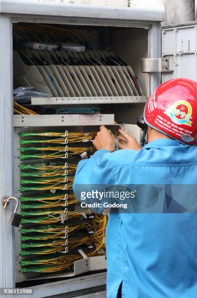 Vietnamese electrician checking plug sockets. Vietnam.