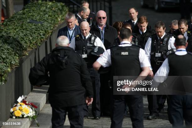Police officers hold a moment of silence in New Palace Yard, north of the Palace of Westminster, the scene of the attack on PC Keith Palmer last...