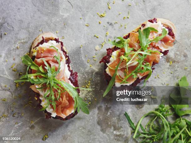 bruschetta with mozzarella, ricotta, beetroot and proscuitto - bruschetta stock pictures, royalty-free photos & images