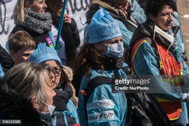 People take part in a demonstration to protest against French government's string of reforms, on March 22, 2018 in Lyon, southeasthern France. Seven...