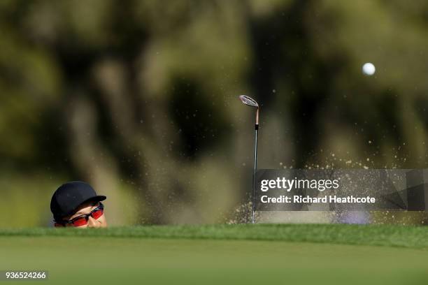 Haotong Li of China plays a shot from a bunker on the first hole during the second round of the World Golf Championships-Dell Match Play at Austin...